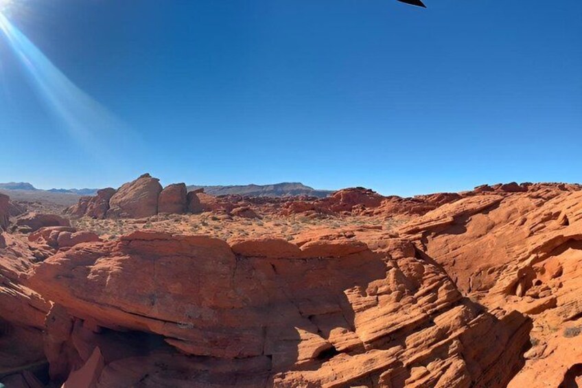 A desert landscape with red rock formations under a clear blue sky. 1
