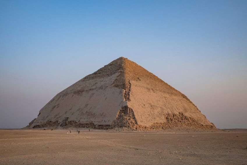A large pyramid in a desert landscape. 1