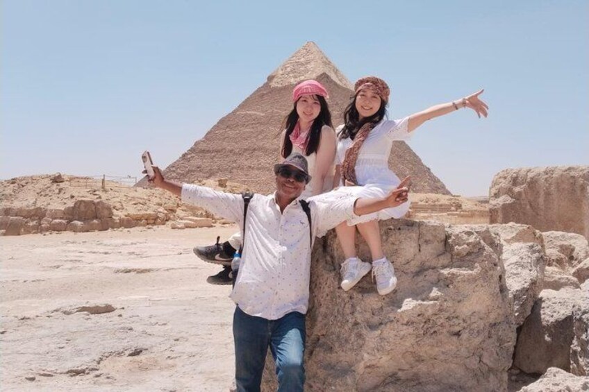 A pyramid, a person, and two children. 3