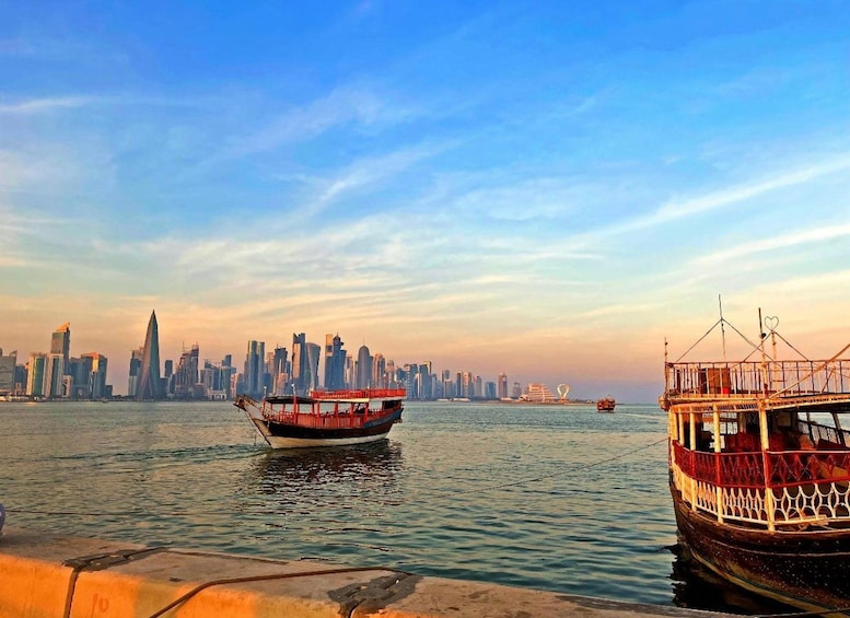 A river with boats, a city skyline in the background, and a clear sky. 1