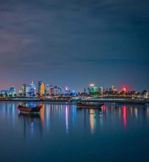 A city skyline at night with illuminated buildings reflecting on calm water. 4