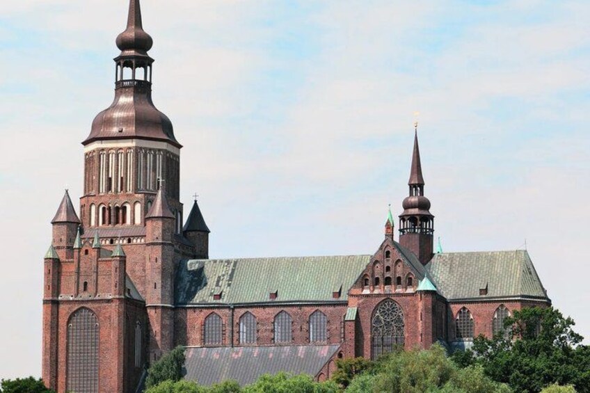A large brick church with multiple spires and arched windows. 2
