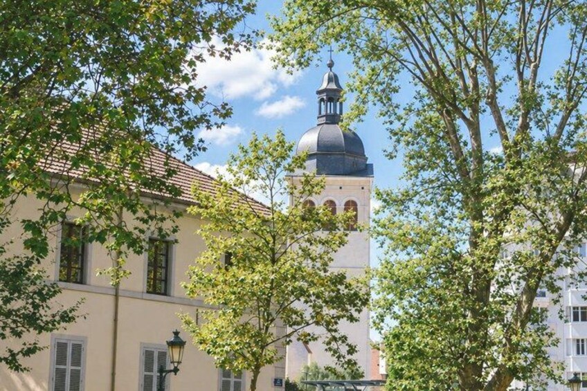 A building with a dome and a bell tower, surrounded by trees. 4