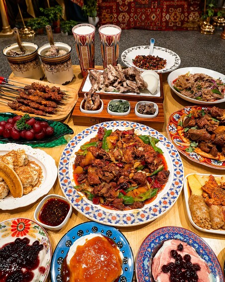 A variety of dishes including skewered meats, a large plate of beef with vegetables, and several bowls of dips. 4