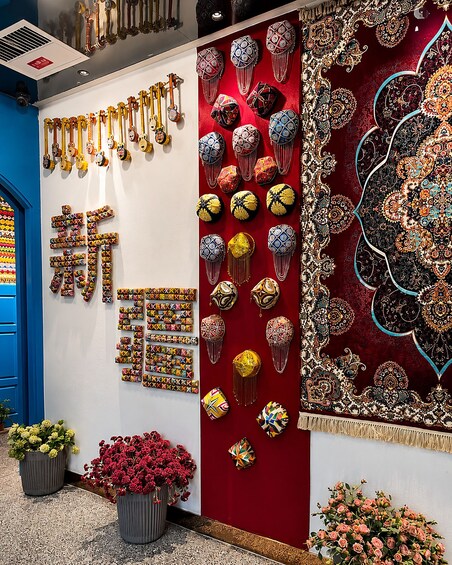 A wall adorned with various musical instruments, decorative items, and a large patterned tapestry. 5