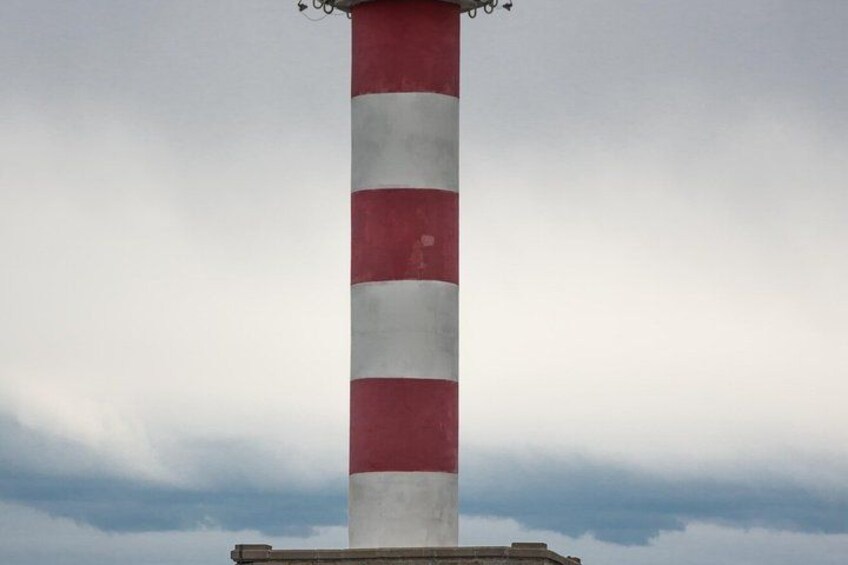 A tall lighthouse with alternating red and white stripes. 5