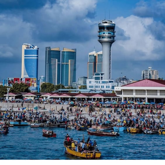A bustling waterfront with numerous boats and a prominent tower structure. 4