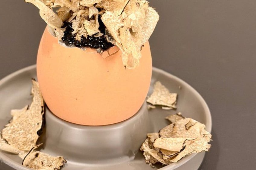 A cracked egg shell with pieces scattered around it. 2