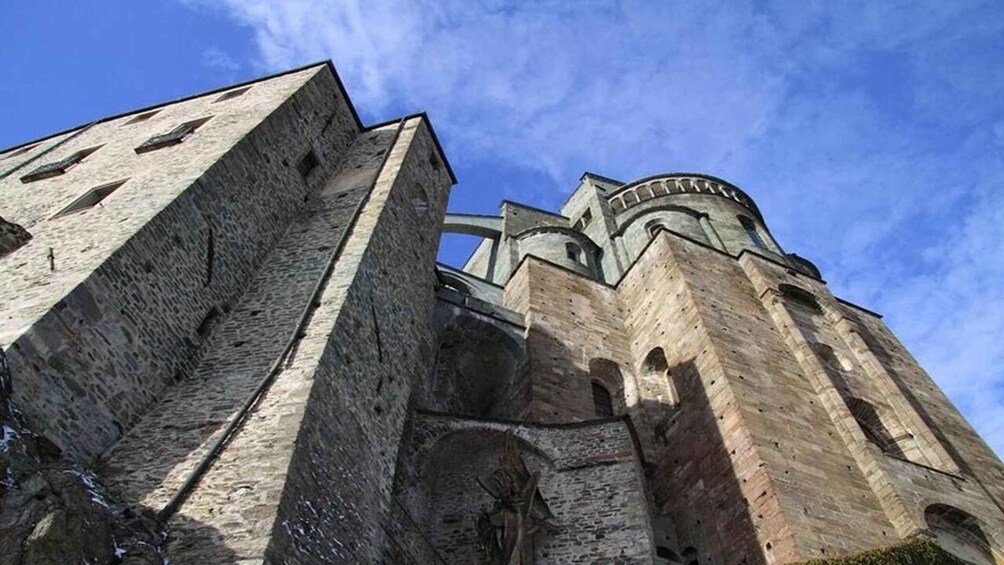 A historic stone building with arched windows and a large tower. 2