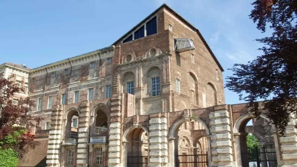A historic building with arched windows and a prominent corner tower. 4