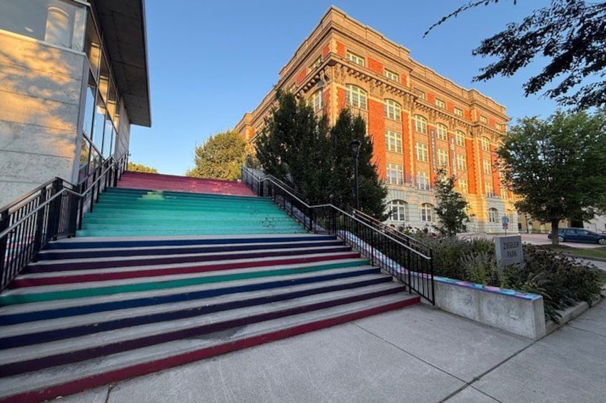 A staircase with colorful steps leading up to a building. 1