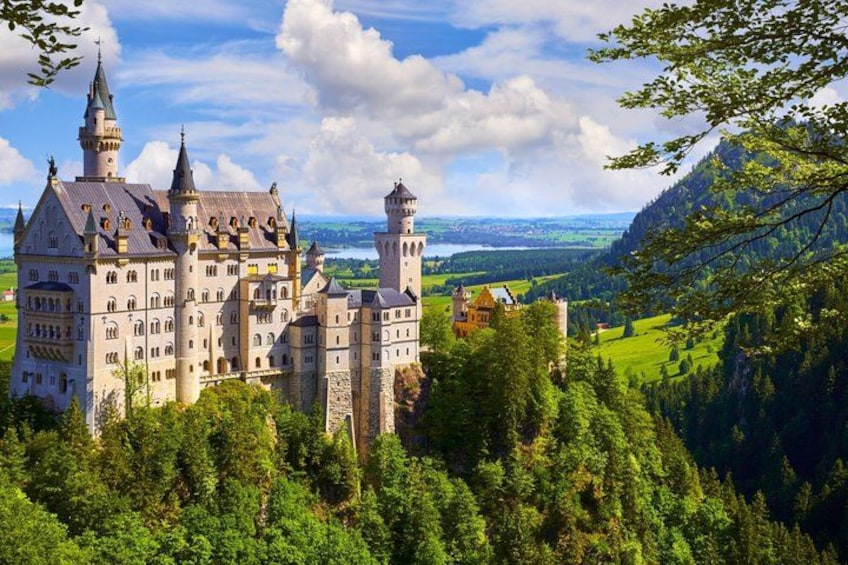 A castle surrounded by lush greenery and mountains. 3
