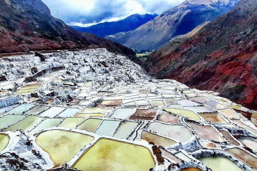 Terraced salt flats with a mountainous backdrop. 1