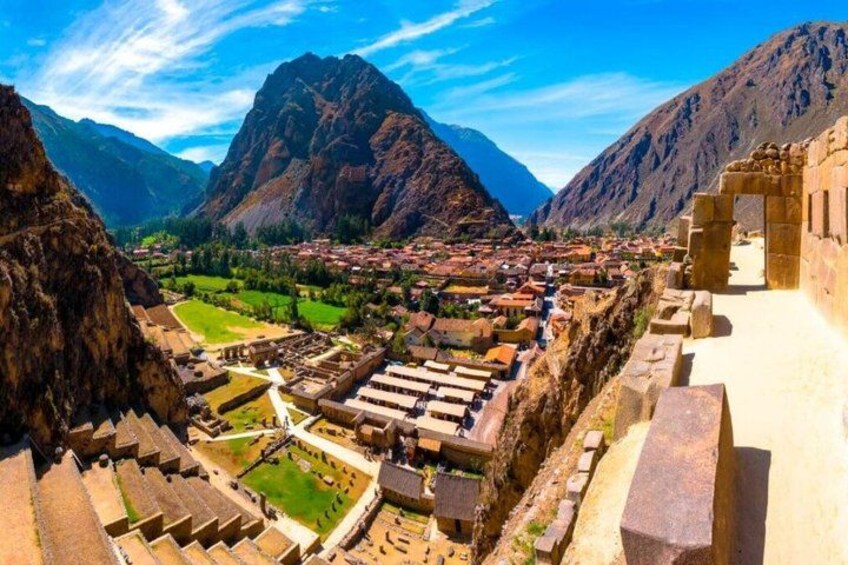 A mountainous landscape with ancient ruins and a town nestled in the valley. 3