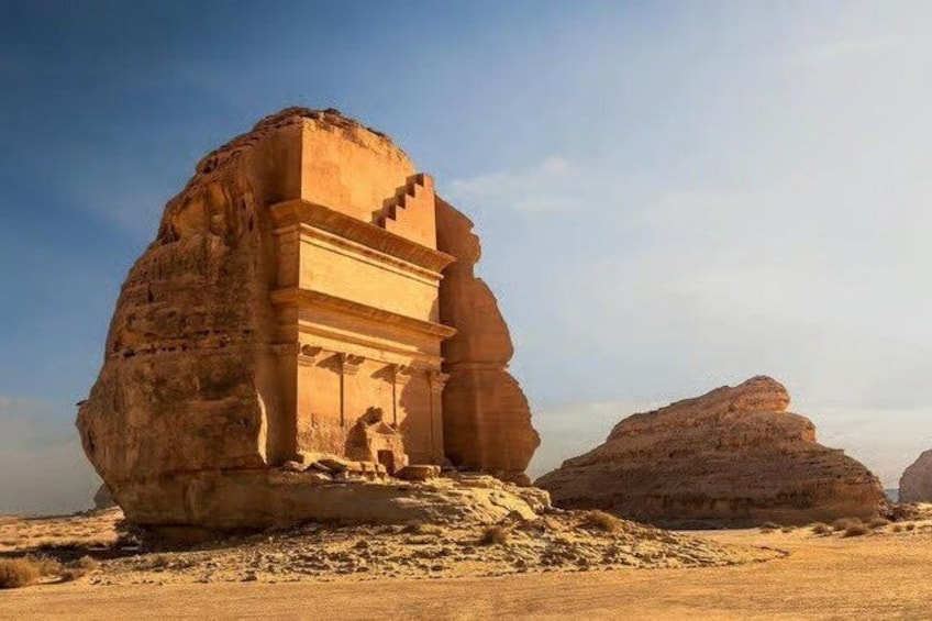 A large rock formation with carved structures. 1