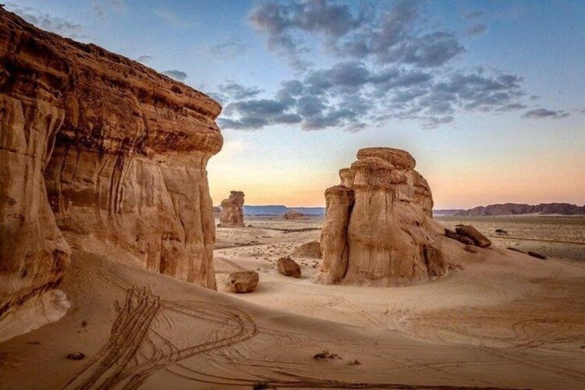 A desert landscape with rock formations and a clear sky. 2