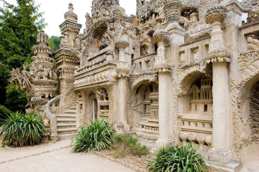 A detailed stone temple with intricate carvings and multiple arches. 1