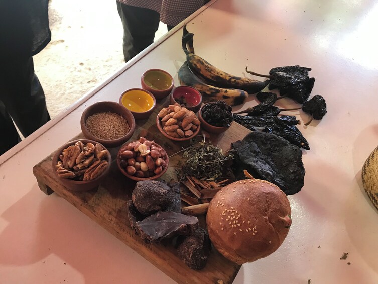 A wooden board with various food items including nuts, dried fruits, and a hamburger. 5