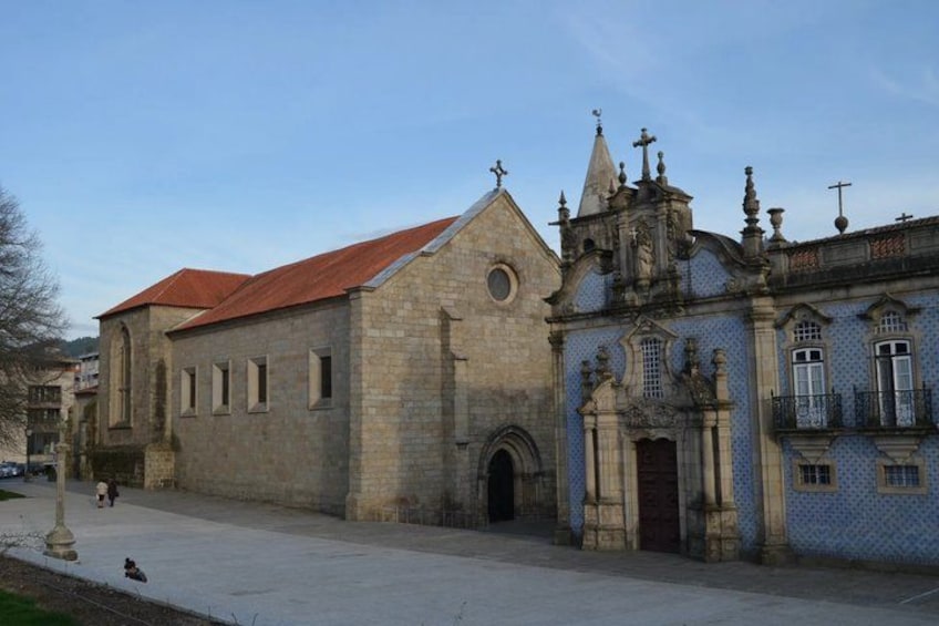 A historic church with a red roof and a blue-tiled facade. 5