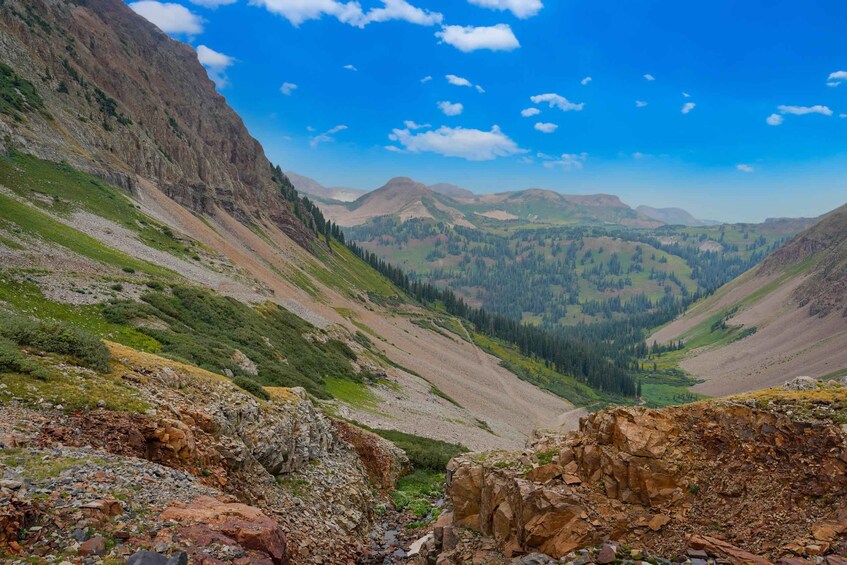 A mountainous landscape with rocky terrain and a valley. 3