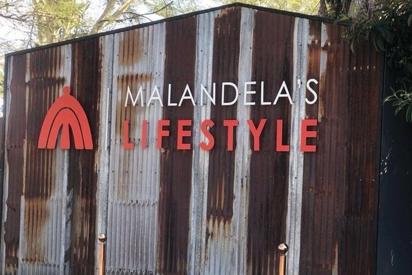 A corrugated metal structure with the text 'MALANDELA'S LIFESTYLE' and a red logo. 5