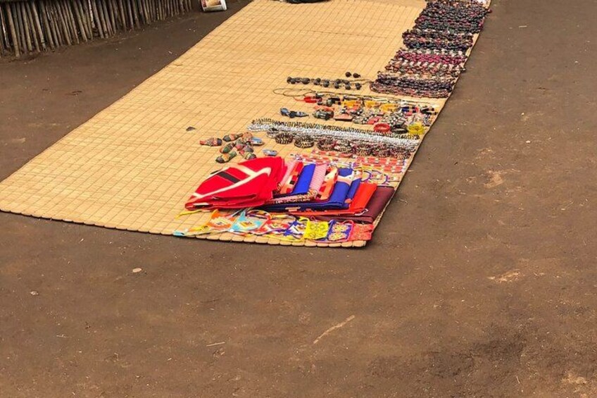 A display of various items laid out on a mat, including colorful fabrics and small objects. 4