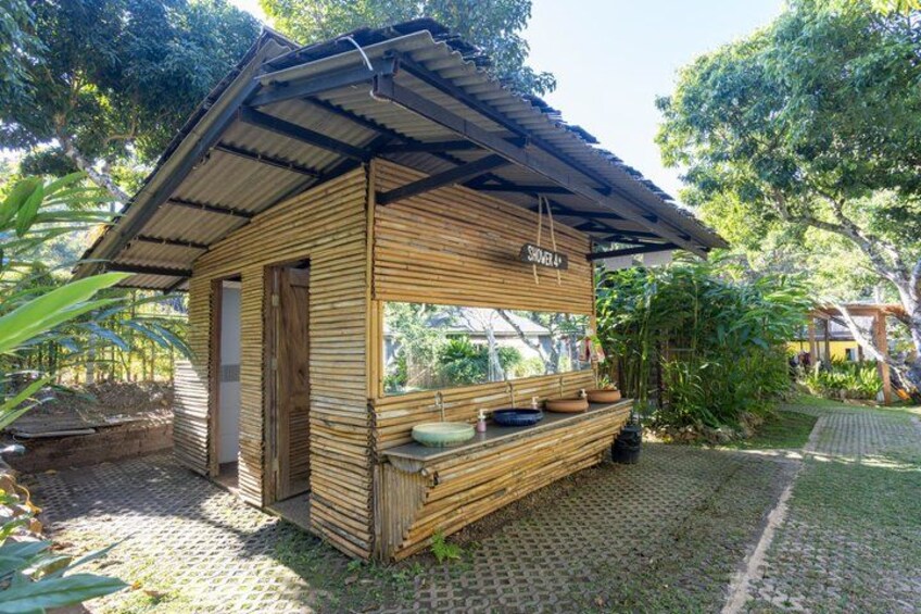 A wooden structure with a sign reading 'SHOWER 4' and a window. 3