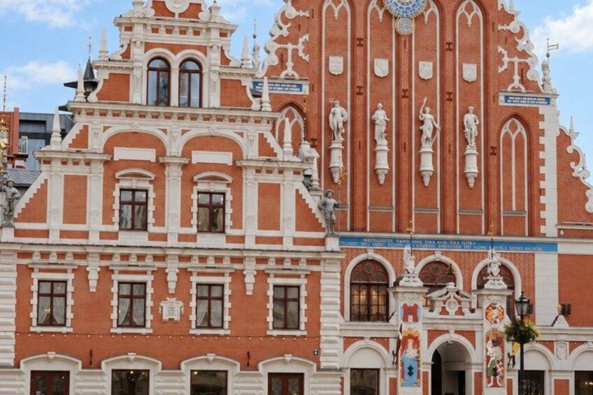 A historic building with ornate architecture, featuring multiple statues and decorative elements. 3