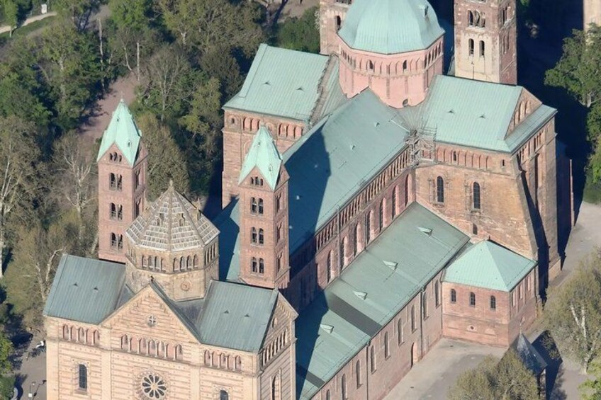 A large, historic church with multiple towers and a central dome, surrounded by trees. 3