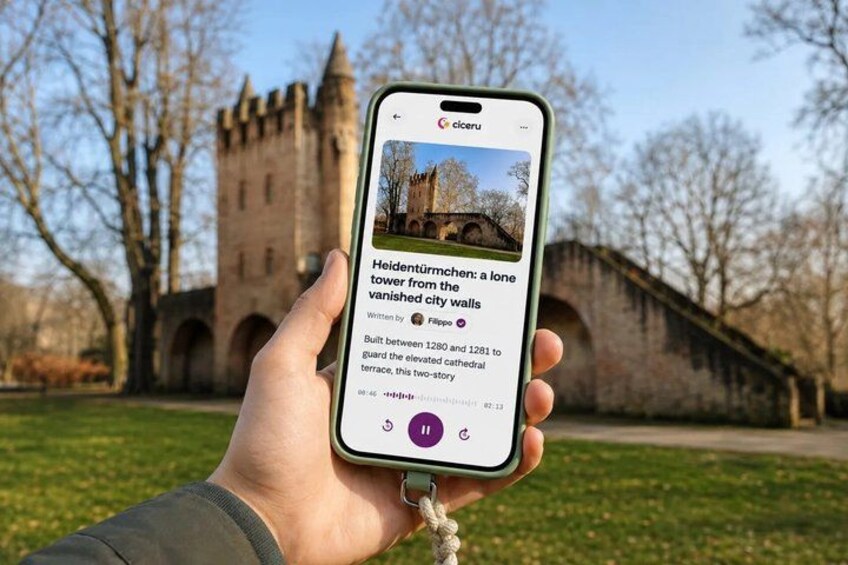 A hand holding a smartphone displaying a castle. 1