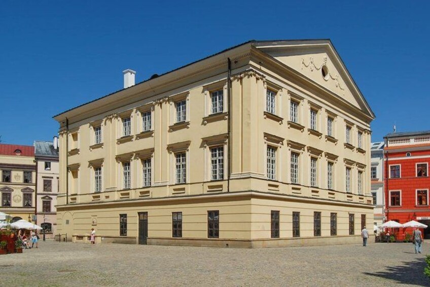 A large, classical building with a symmetrical facade, multiple windows, and a central entrance. 5