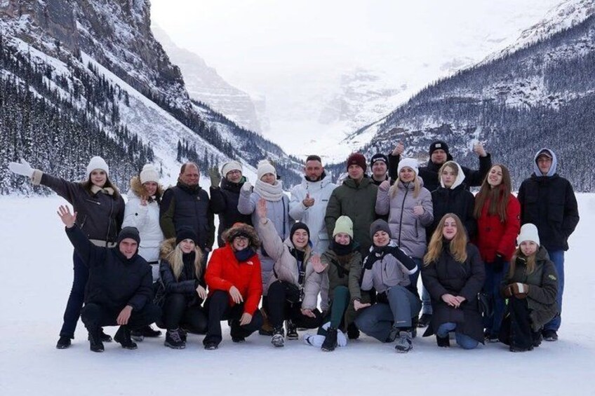A group of people posing in a snowy mountainous landscape. 2