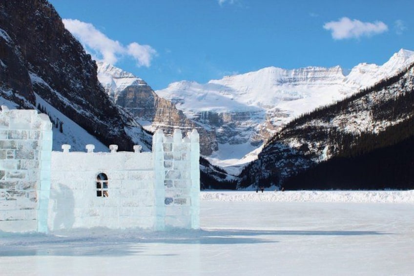 A snow-covered mountain landscape with a frozen lake and a castle-like structure. 5