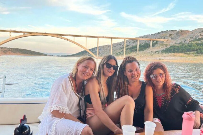 A group of people on a boat with a bridge in the background. 4