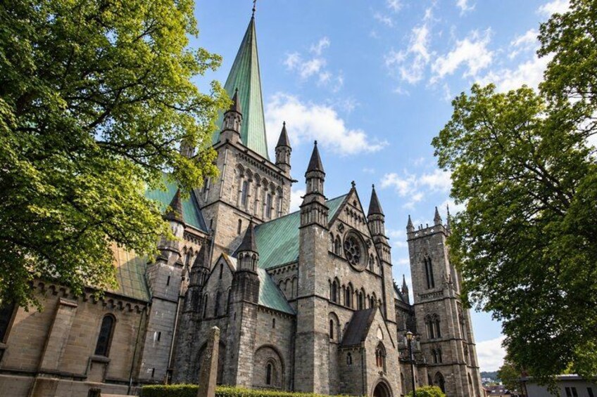 A historic church with a tall spire and multiple towers. 3