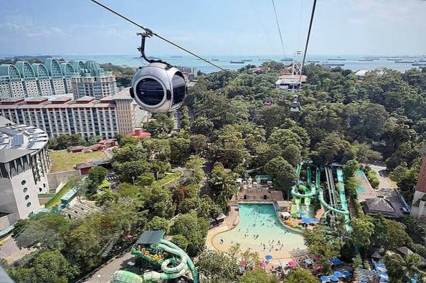 A cable car system, a water park, and a cityscape with buildings and greenery. 3