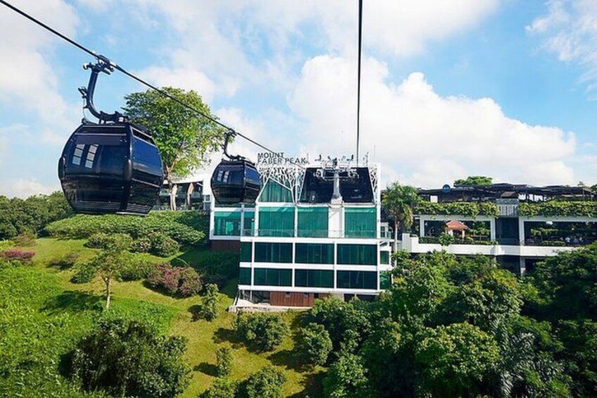 A cable car system with a building in the background. 1