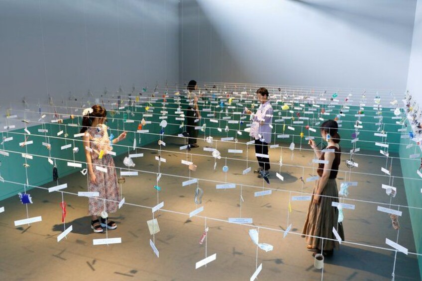 An indoor art installation with people observing. 3