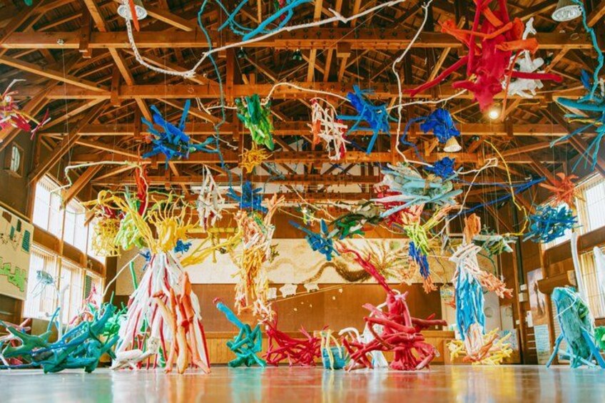A room with colorful hanging decorations and wooden beams. 4