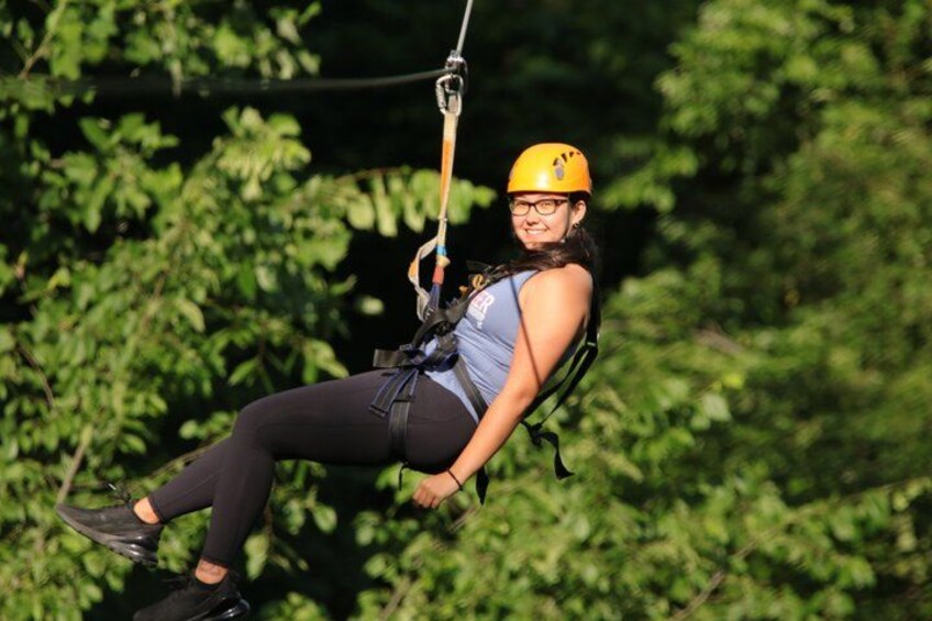 A person zip-lining through a forested area. 4