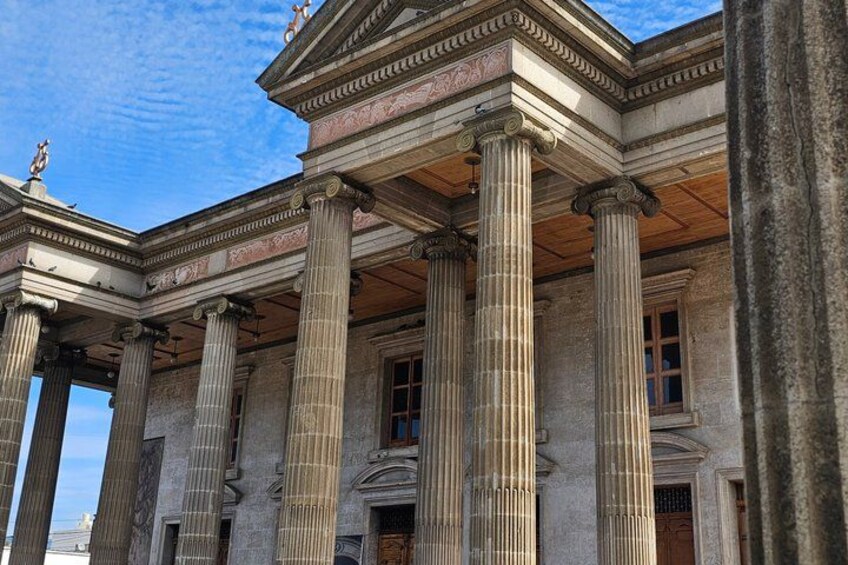 A classical building with large columns and a pediment. 2