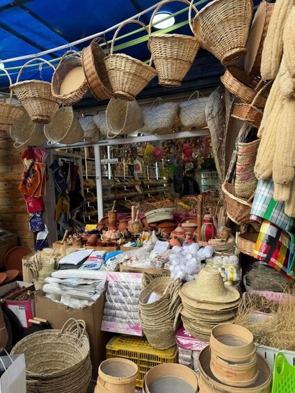 A market stall with woven baskets, pottery, and textiles. 4