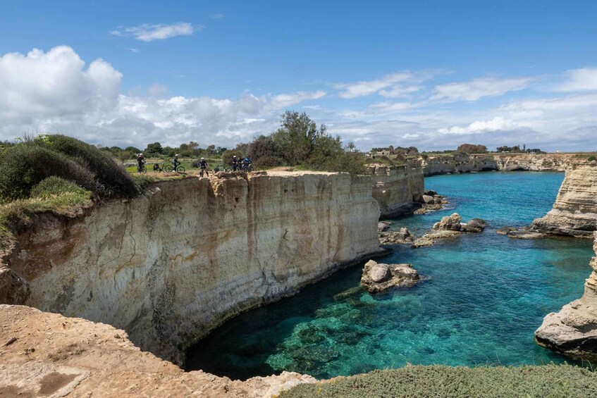 A coastal landscape with cliffs and clear blue water. 2