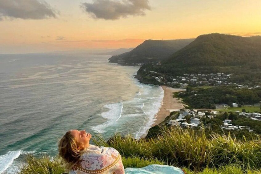 A coastal landscape with a beach, ocean, and hills. 2