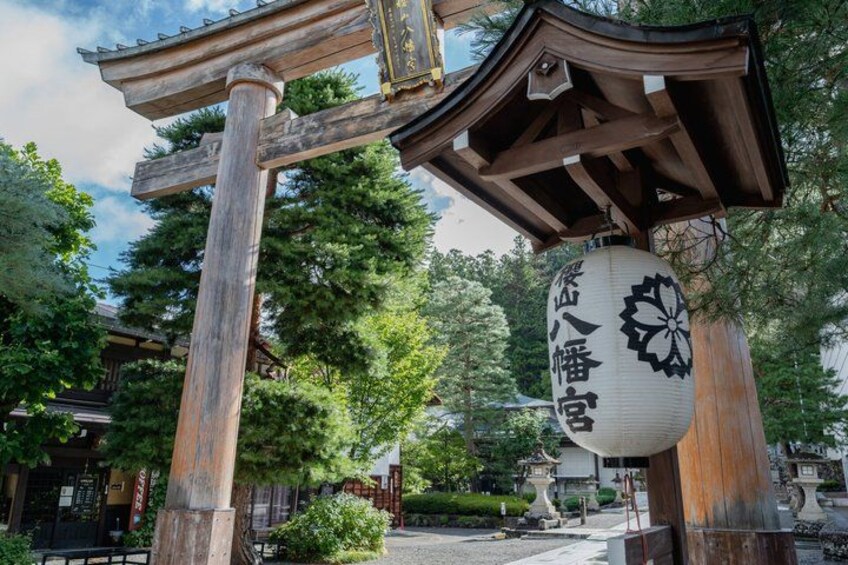 A traditional Japanese torii gate with a hanging lantern. 4