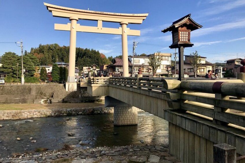 A traditional Japanese torii gate, a stone bridge, and a pagoda. 5