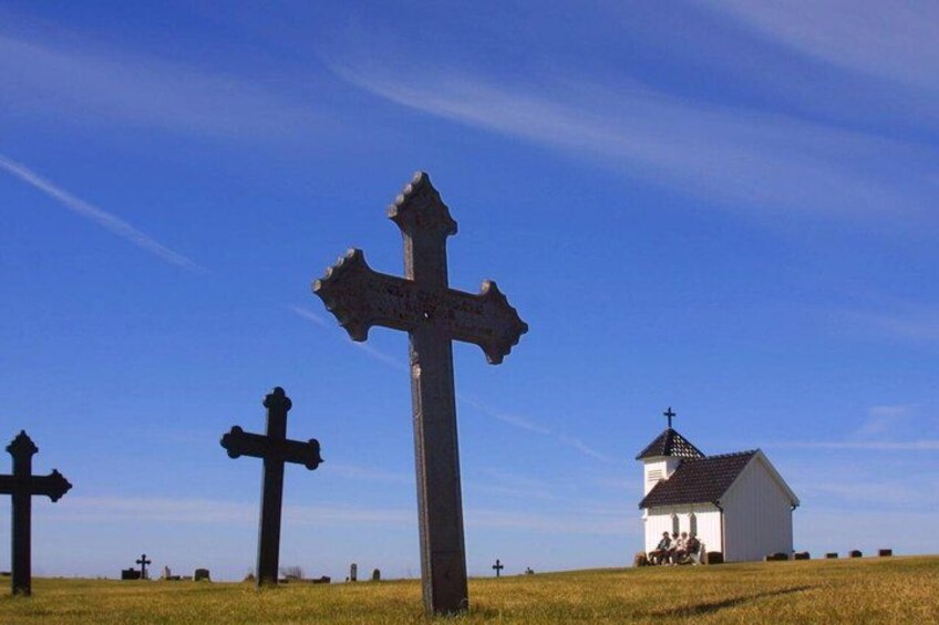 A field with crosses and a white church. 1