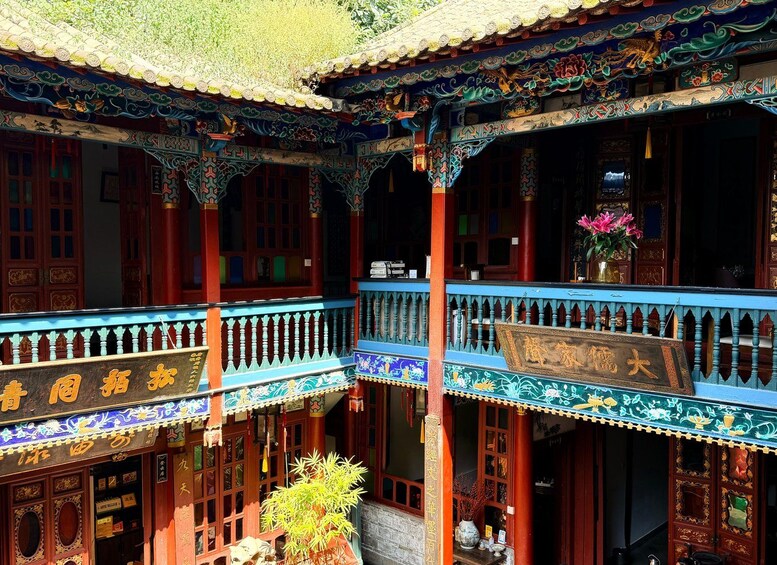 A traditional Chinese building with ornate decorations and a signboard. 2