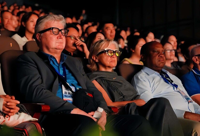 People seated in an auditorium. 4