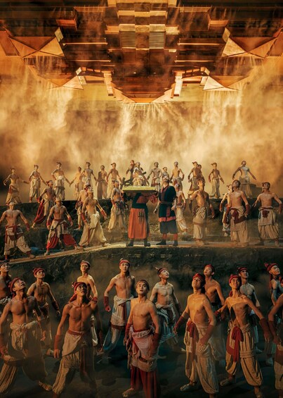 A group of people in historical costumes gathered in an open-air setting with a wooden ceiling structure. 1